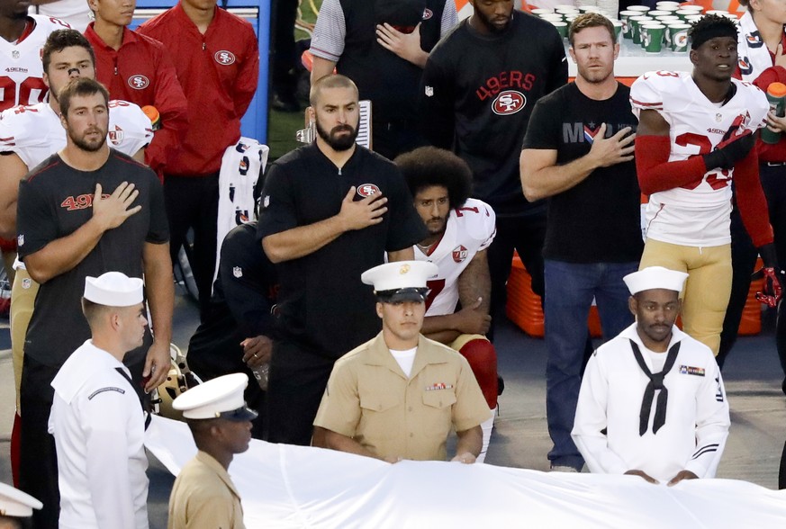 FILE - In this Sept. 1, 2016, file photo, San Francisco 49ers quarterback Colin Kaepernick, center, kneels during the National Anthem before an NFL preseason football game against the San Diego Charge ...