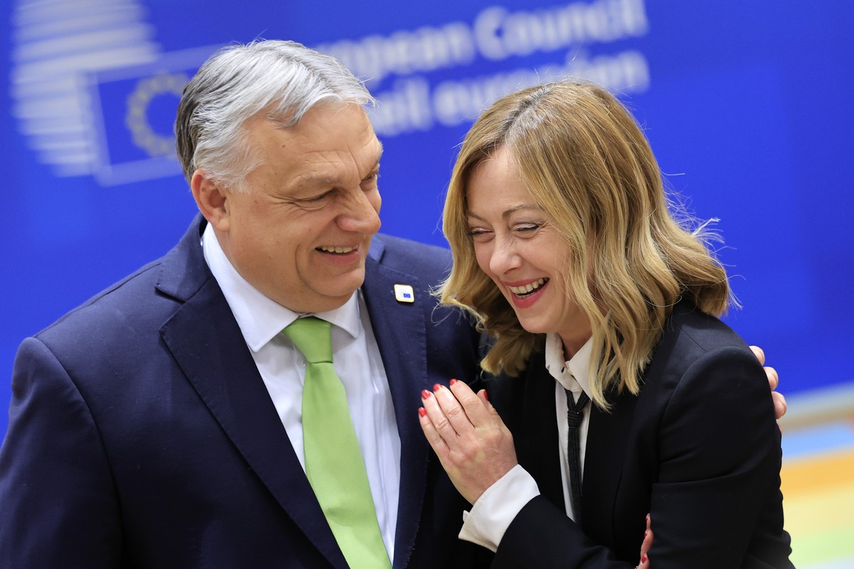 FILE - Hungary's Prime Minister Viktor Orban, left, speaks with Italy's Premier Giorgia Meloni during a round table meeting at an EU Summit in Brussels, Thursday, March 21, 2024. Meloni' ...