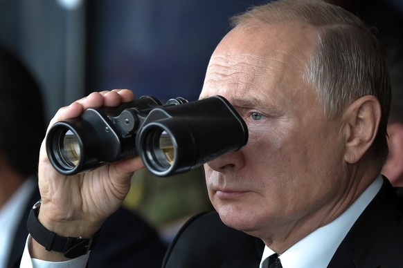 Russian President Vladimir Putin holds binoculars while watching the military exercises Center-2019 at Donguz shooting range near Orenburg, Russia, in Sept. 20, 2019. Russian President Vladimir Putin& ...