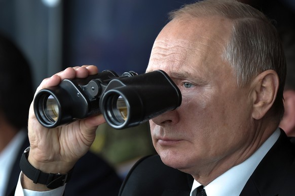 Russian President Vladimir Putin holds binoculars while watching the Center-2019 military exercises at the Donguz firing range near Orenburg, Russia, on Sept. 20, 2019. Russian President Vladimir Putin &…