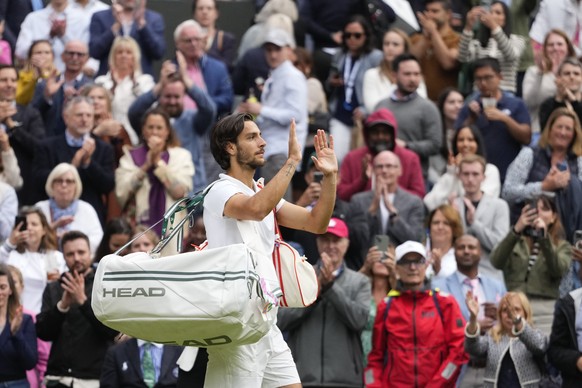 Lorenzo Musetti of Italy waves as he leaves Centre Court following his semifinal loss to Novak Djokovic of Serbia at the Wimbledon tennis championships in London, Friday, July 12, 2024. (AP Photo/Kirs ...