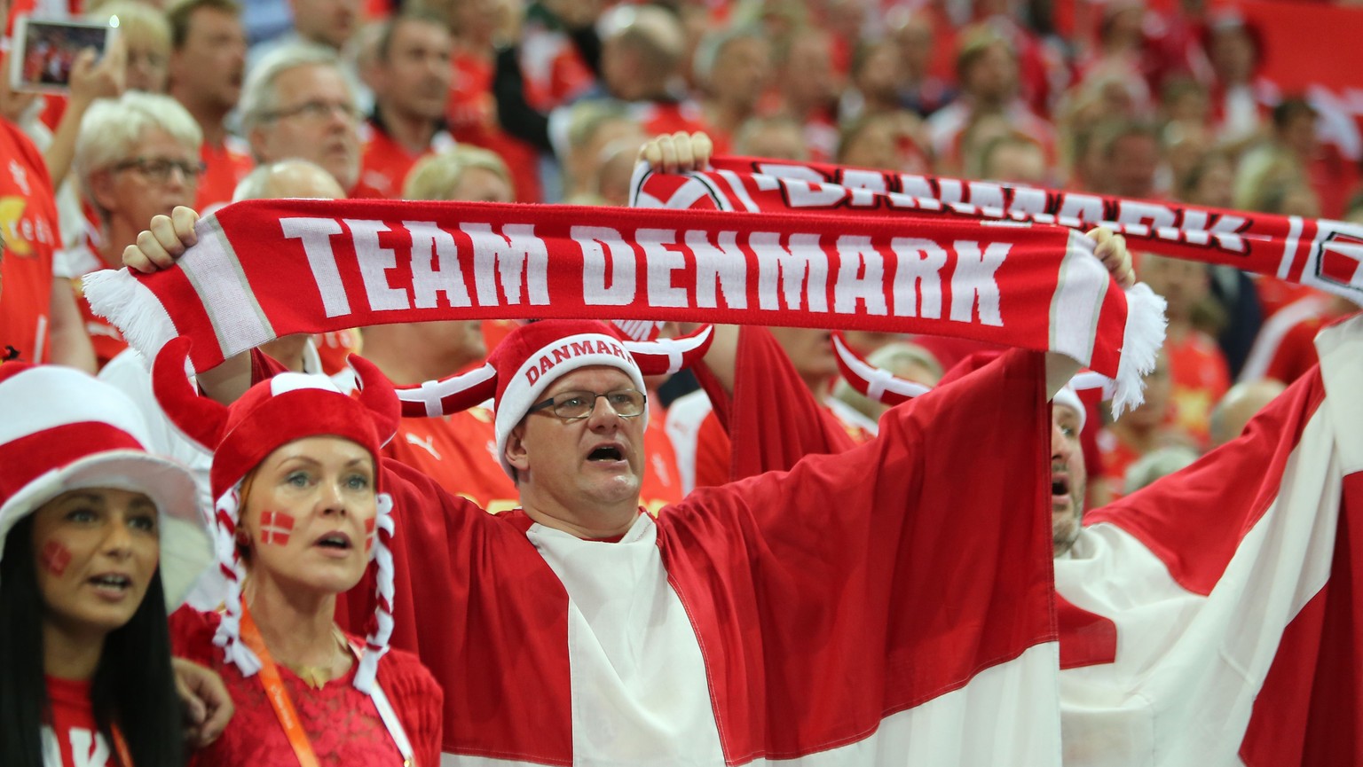 Supporters of Denmark sing their national anthem during the 24th Men&#039;s Handball World Championships quarterfinals match between Denmark and Spain at the Lusail Multipurpose Hall in Doha on Januar ...