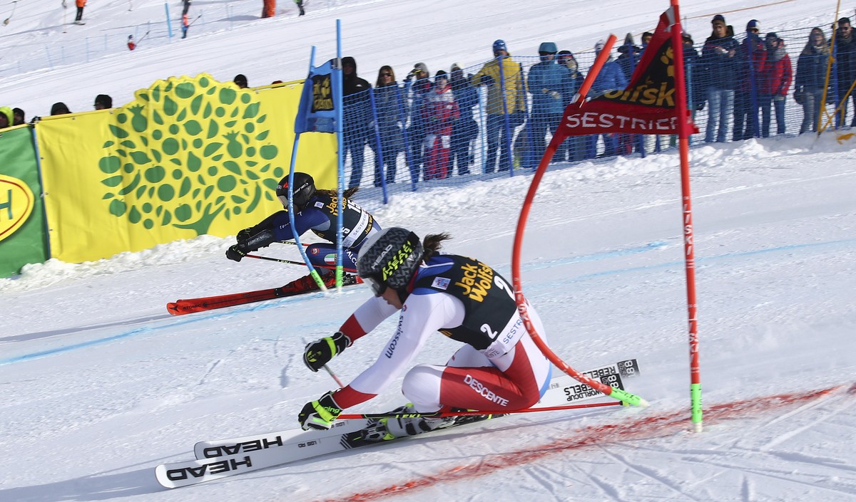 Italy's Sofia Goggia, left, and Switzerland's Wendy Holdener, compete during an alpine ski, women's World Cup parallel giant slalom in Sestriere, Italy, Sunday, Jan. 19, 2020. (AP Photo ...