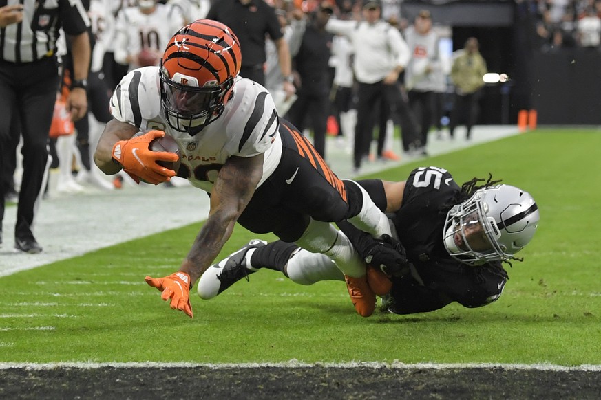 Cincinnati Bengals running back Joe Mixon (28) dives into the endzone for a touchdown against Las Vegas Raiders free safety Trevon Moehrig (25) during the first half of an NFL football game, Sunday, N ...