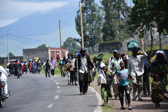 People fleeing fighting between government supporters and rebels in Congo.