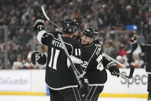 Los Angeles Kings defenseman Drew Doughty, center, celebrates with center Anze Kopitar (11) and left wing Kevin Fiala (22) after scoring during the second period of an NHL hockey game against the Anah ...