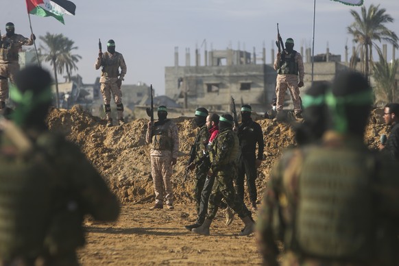 Israeli Yarden Bibas, 34, who has been held hostage by Hamas in Gaza since October 7, 2023, is escorted by Hamas fighters before being handed over to the Red Cross in Khan Younis, southern Gaza Strip, ...