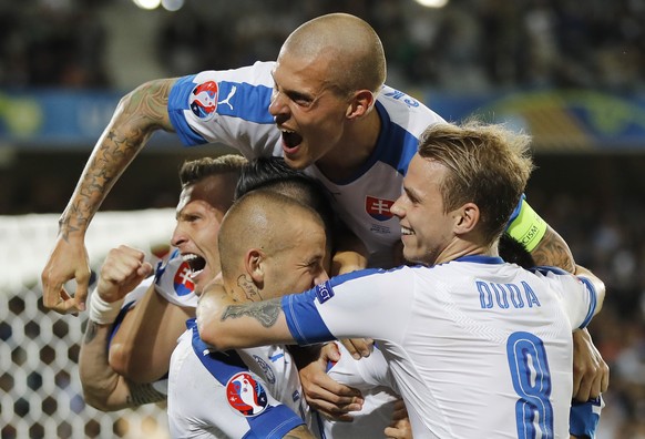 Slovakia&#039;s players celebrate after Marek Hamsik scored his side&#039;s second goal during the Euro 2016 Group B soccer match between Russia and Slovakia at the Pierre Mauroy stadium in Villeneuve ...