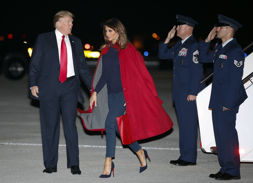 President Donald Trump and first lady Melania Trump arrive on Air Force One at Palm Beach International Airport, in West Palm Beach, Fla., Friday, Feb. 2, 2018. (AP Photo/Carolyn Kaster)