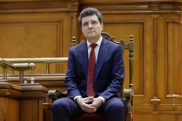 epa12136658 Romania&#039;s President Nicusor Dan looks on as he attends a swearing-in ceremony for his first term in office during a solemn session at the Parliament Palace in Bucharest, Romania, 26 M ...