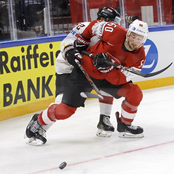 Austria&#039;s defender Clemens Unterweger, left, vies for the puck with Switzerland&#039;s forward Tristan Scherwey, right, during the IIHF 2018 World Championship preliminary round game between Swit ...