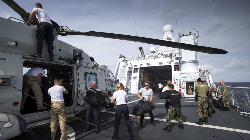 epa06191554 A handout photo made available by the Dutch Department of Defense on 08 September 2017 shows Dutch soldiers loading a helicopter onboard the Royal Dutch Navy vessel &#039;Zr. Ms. Zeeland&# ...