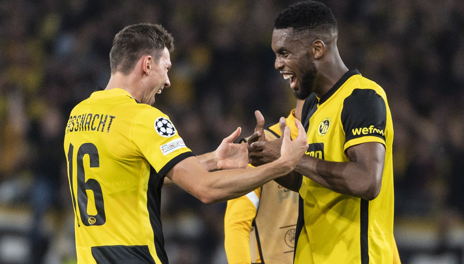 Young Boys&#039; Christian Fassnacht, left, and the scorer of the winning goal, Jordan Siebatcheu, celebrate after winning the UEFA Champions League group F soccer match between BSC Young Boys and Man ...