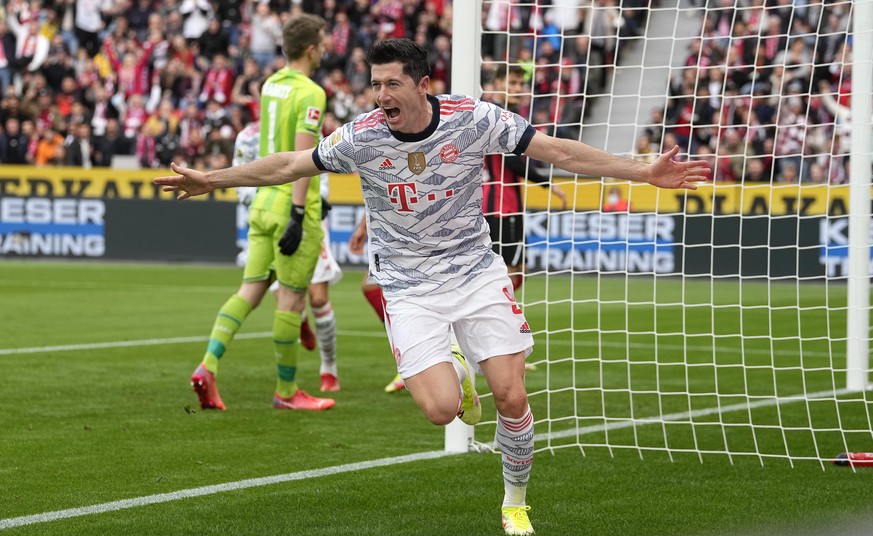 Bayern's Robert Lewandowski celebrates after scoring the opening goal during the German Bundesliga soccer match between Bayer Leverkusen and Bayern Munich in Leverkusen, Germany, Sunday, Oct. 17, 2021 ...
