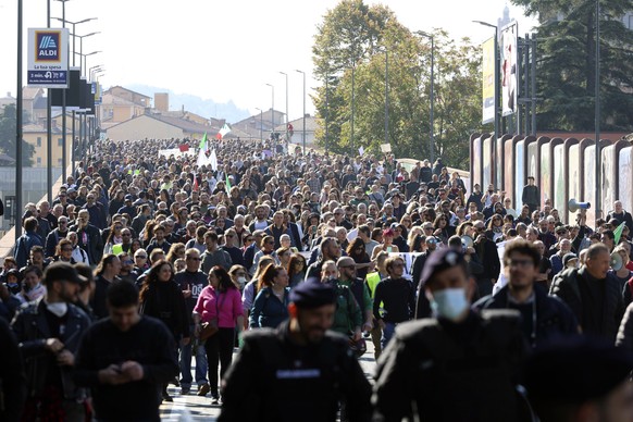 People march during a protest against the COVID Green Pass in Bologna, Italy, Friday, Oct. 15, 2021. Protests erupted in Italy on Friday as one of the most stringent anti-coronavirus measures in Europ ...