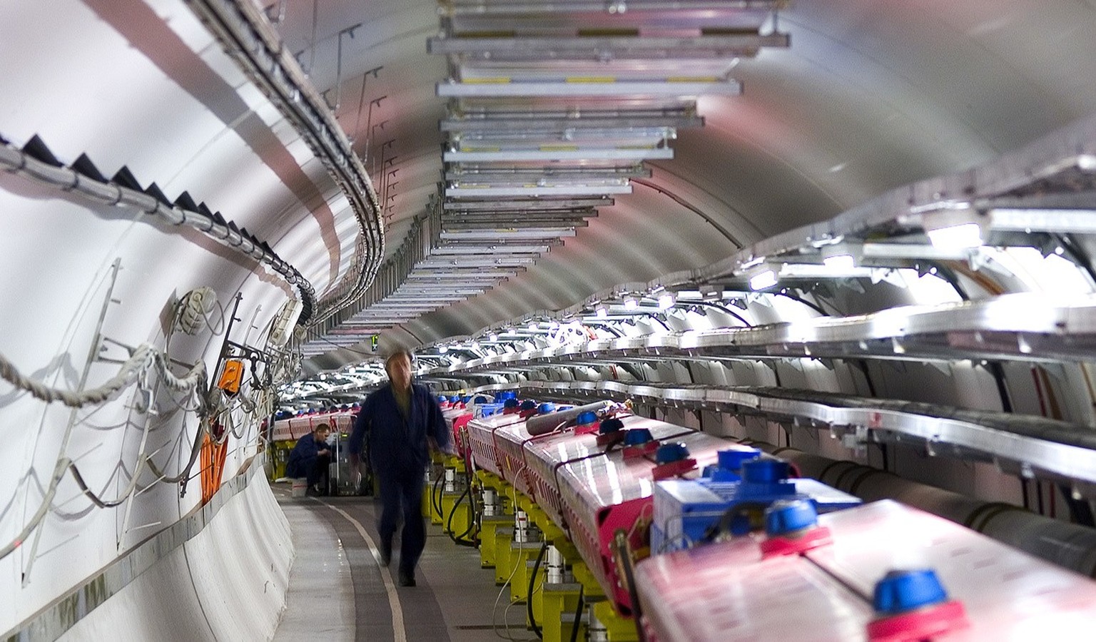 In this 2005 photo provided by CERN, the European Organization for Nuclear Research, technicians check the magnets that will direct protons towards the target for the CERN Neutrinos to Gran Sasso (CNG ...