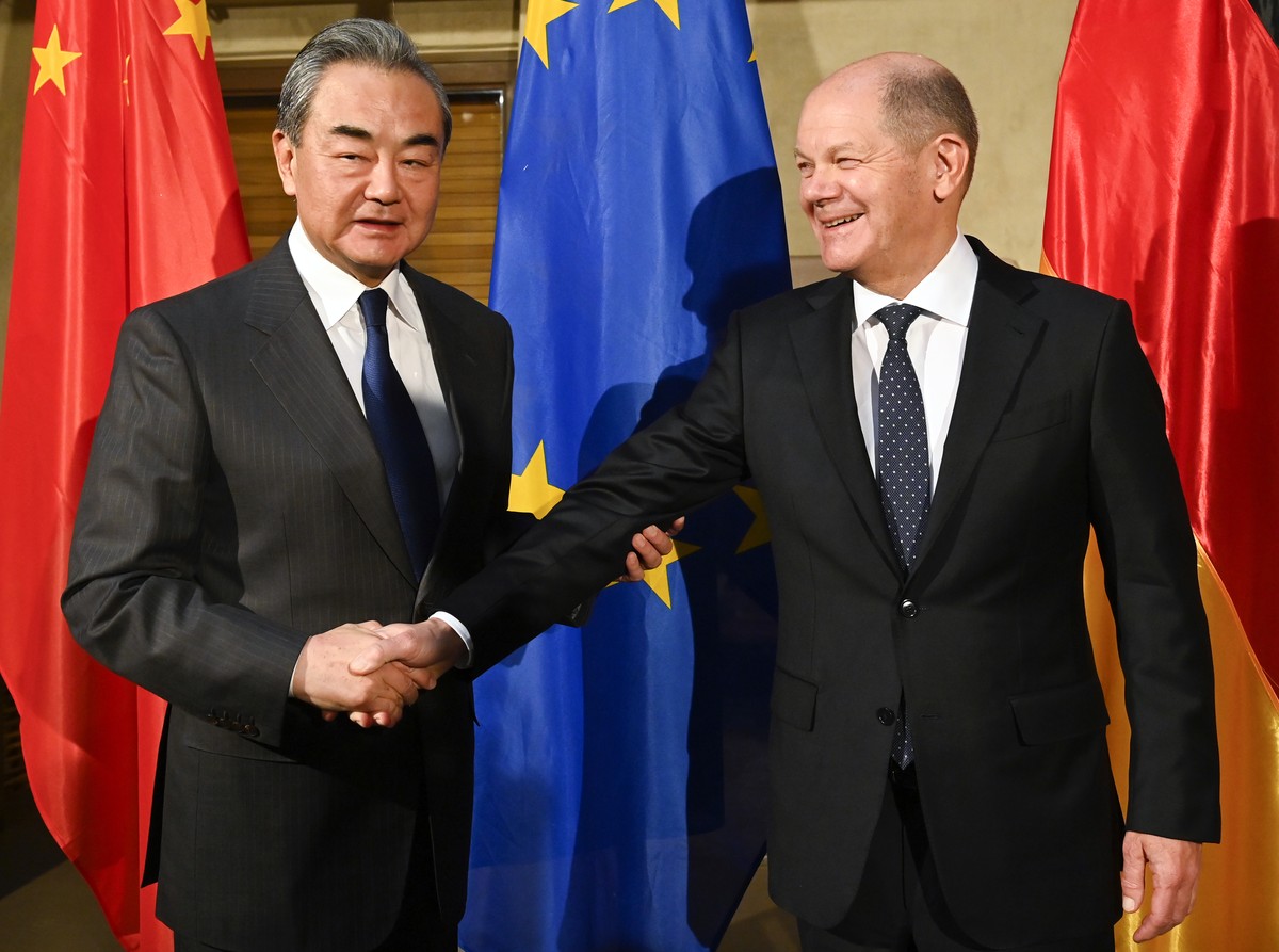German Chancellor Olaf Scholz, right, shake hands with China's Director of the Office of the Central Foreign Affairs Commission Wang Yi at the Munich Security Conference in Munich, Germany, Frida ...
