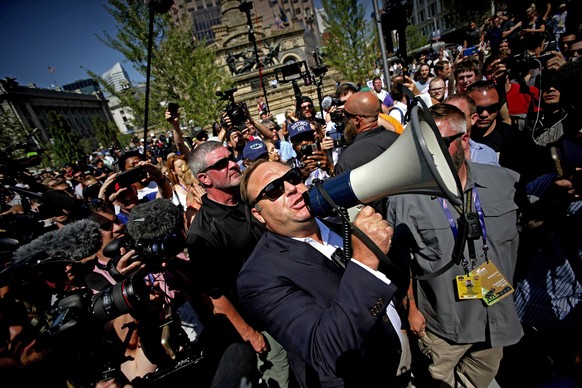 epa06913532 (FILE) - US radio host Alex Jones (C) uses a megaphone to speak to crowds near the Quicken Loans Arena, the venue for the 2016 Republican National Convention (RNC), in Cleveland, Ohio, USA ...