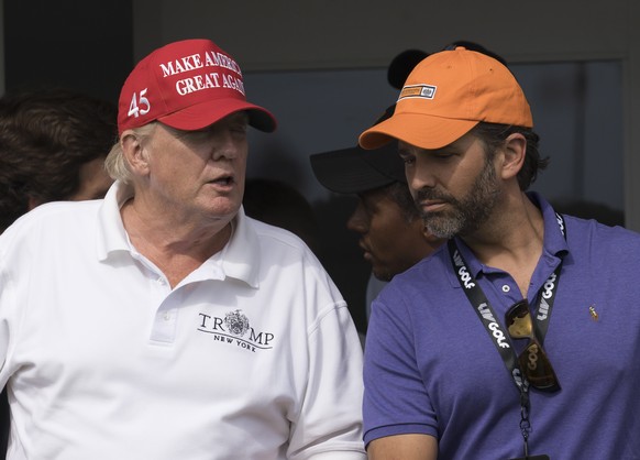 epa10100938 Former US President Donald J. Trump (L) and his son Donald Trump Jr. (R) watch the third round of the LIV Golf Bedminster invitational, part of the new LIV Golf Invitational Series, at the ...