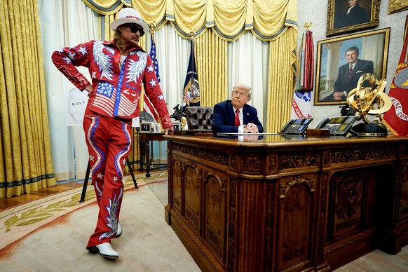epa12002047 US Singer Kid Rock (L), speaks to US President Donald Trump during an executive order signing in the Oval Office at the White House in Washington, DC, USA, 31 March 2025. The order directs ...