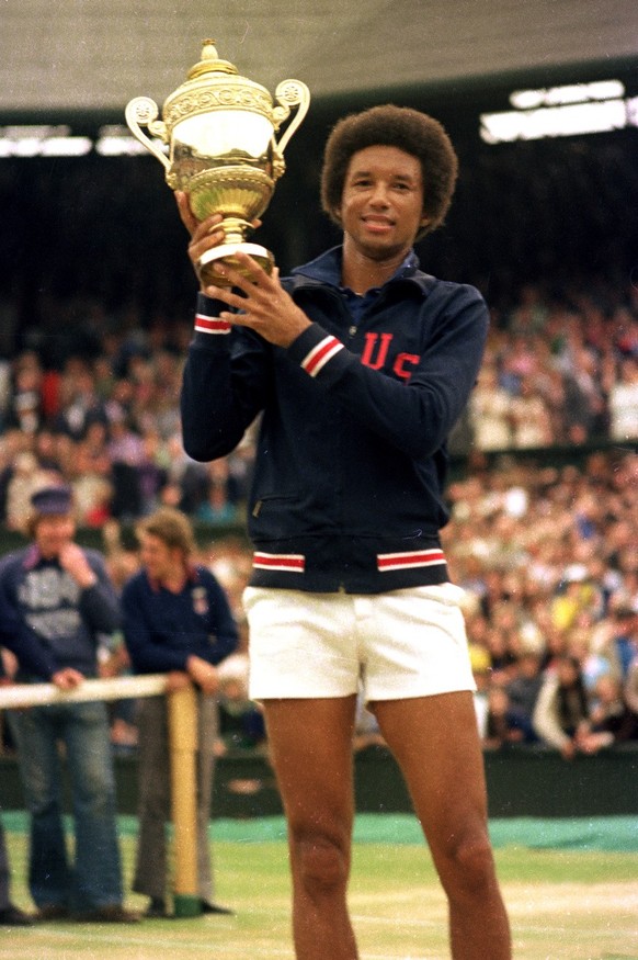 FILE - In this July 5, 1975 file photo, Arthur Ashe holds his Wimbledon trophy cup after defeating fellow American Jimmy Connors in the final match of the men&#039;s singles championship at the All En ...