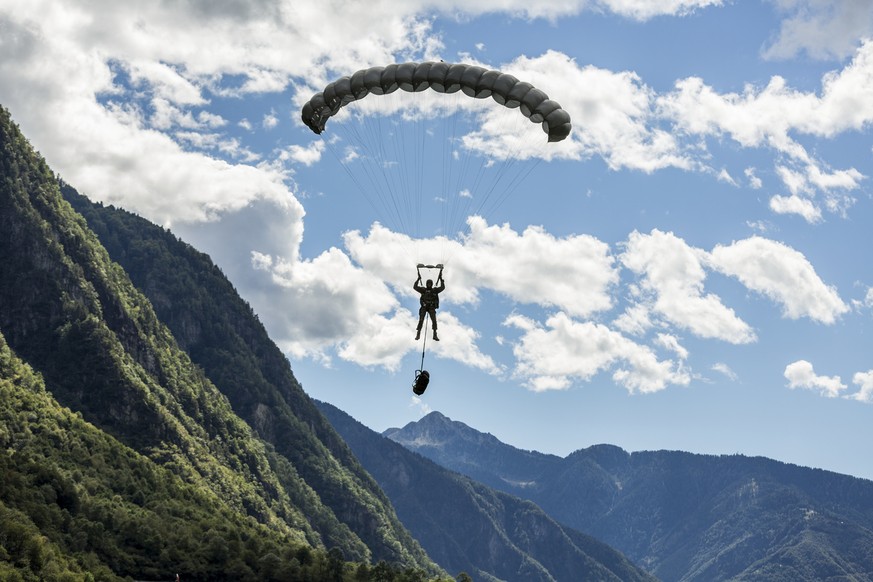 A parascout glides toward the ground, pictured near Locarno in the canton of Ticino, Switzerland, on October 4, 2013. The parascouts of the Swiss Armed Forces are stationed at the military airbase Loc ...