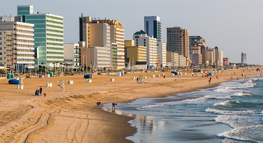 VIRGINIA BEACH, VIRGINIA - JULY 13, 2017: Dawn lights the oceanfront high-rise hotels lining the boardwalk at this popular tourist destination.