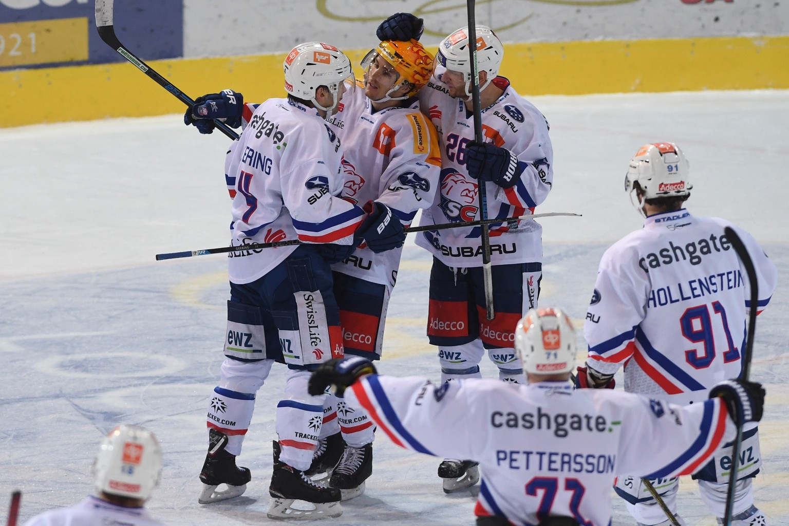 From left, Zurich&#039;s player Patrick Geering celebrate with Zurich&#039;s player Pius Suter and Zurich&#039;s player Simon Bodenmann, the 2-3 overtime goal, during the preliminary round game of Nat ...