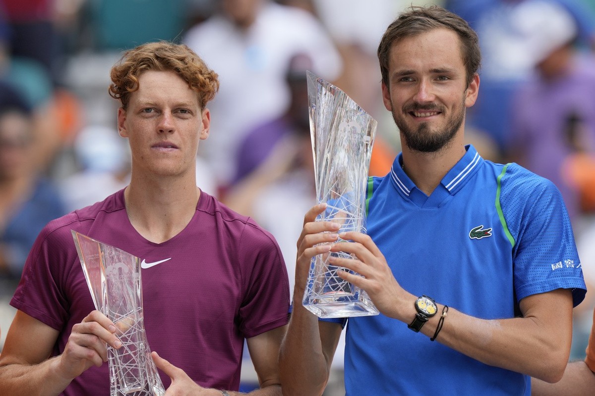 Daniil Medvedev, of Russia, right, and Jannik Sinner, of Italy, pose with their trophies after Medvedev beat Sinner, 7-5, 6-3, during the men's singles finals of the Miami Open tennis tournament, ...