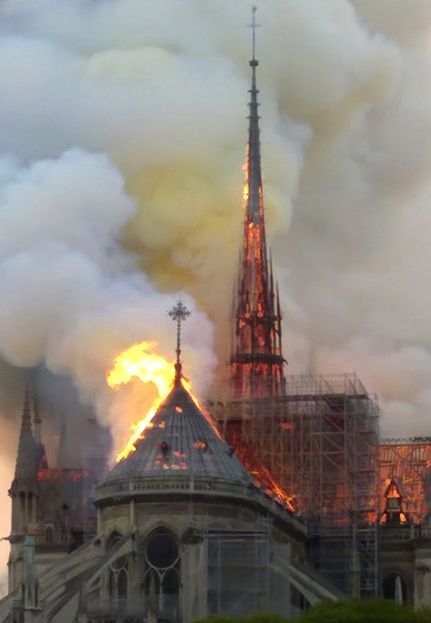 The spire and parts of Notre Dame cathedral is on fire in Paris, Monday, April 15, 2019. A catastrophic fire engulfed the upper reaches of Paris' soaring Notre Dame Cathedral as it was undergoing ...