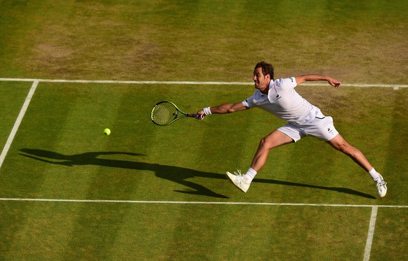 LONDON, ENGLAND - JULY 08: Richard Gasquet of France stretches for forehand in his Gentlemens Singles Quarter Final match against Stanislas Wawrinka of Switzerland during day nine of the Wimbledon Law ...