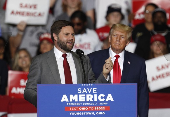 epa10190800 J.D. Vance (L), Republican Nominee for US Senator for Ohio, appears on stage at a Save America rally with former US President Donald Trump (R) at the Covelli Centre in Youngstown, Ohio, US ...