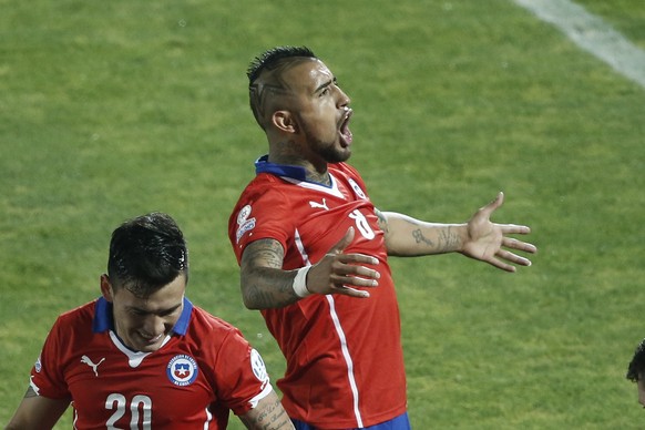 Chile&#039;s Arturo Vidal, right, reacts after his teammate Mauricio Isla scored against Uruguay during a Copa America quarterfinal soccer match at the National Stadium in Santiago, Chile, Wednesday,  ...