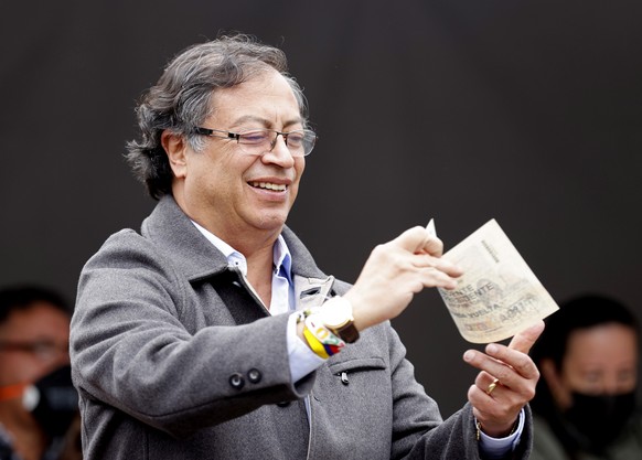 epa10022539 Colombian presidential candidate Gustavo Petro shows his vote in a polling station in Bogota, Colombia, 19 June 2022. Rodolfo Hernandez and leftist candidate Gustavo Petro are competing in ...