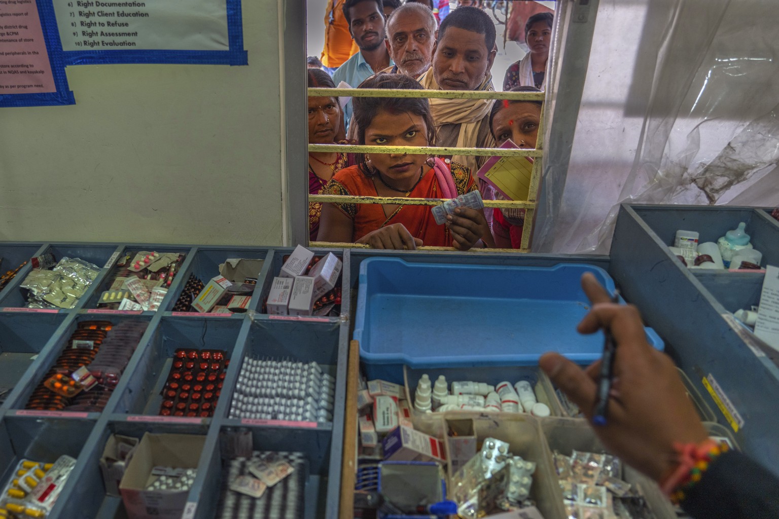 Aanchal Prakash, who has sickle cell disease listens to instructions from a pharmacist before receiving free medicine at the primary health care in Ambikapur district, Chhattisgarh state, India, Monda ...