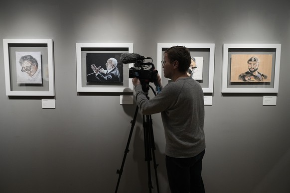 A cameraman films prior to an opening ceremony of the exhibition of artworks of Viktor Bout, a Russian arms dealer who was sentenced to 25 years in the United States, at the Mosfilm studio in Moscow,  ...