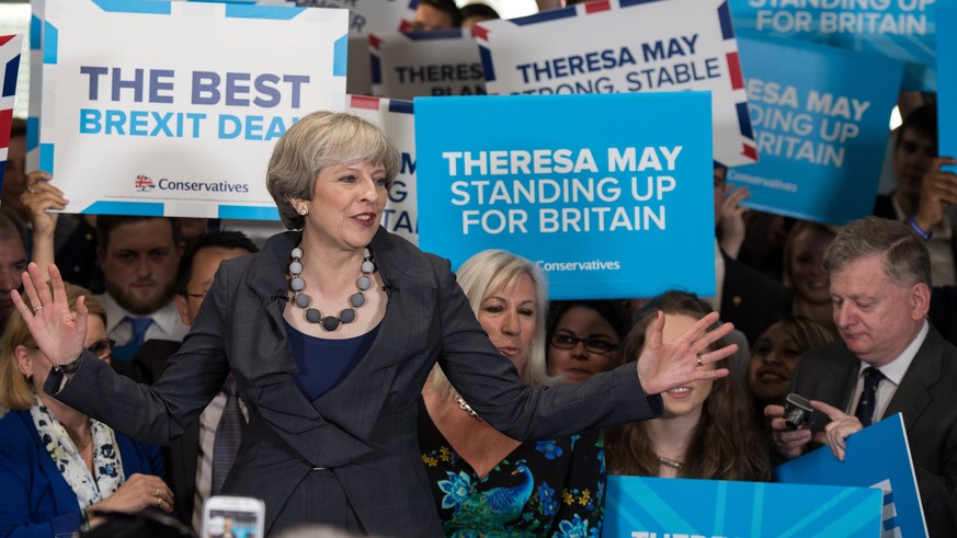 epa06004413 Theresa May, British prime minister and leader of the Conservative Party, speaks to supporters during a general election campaign tour stop at Pride Park Stadium in Derby, Britain, 01 June ...