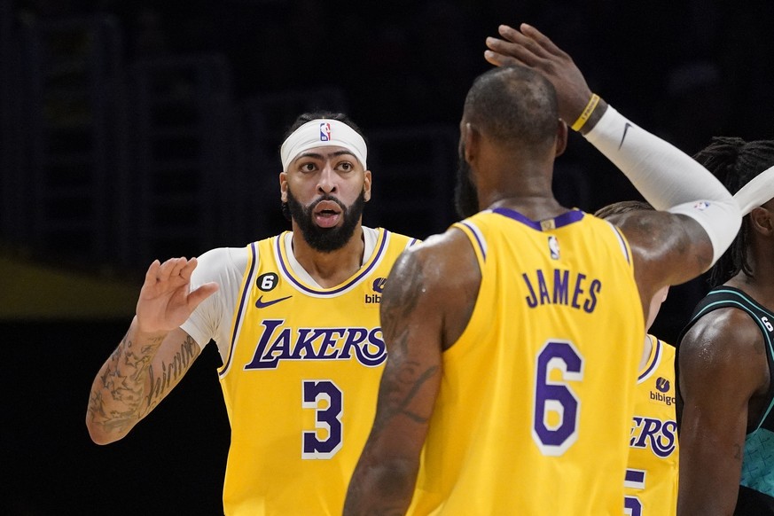 Los Angeles Lakers forward Anthony Davis, left, is congratulated by forward LeBron James after scoring during the second half of an NBA basketball game against the Portland Trail Blazers Wednesday, No ...