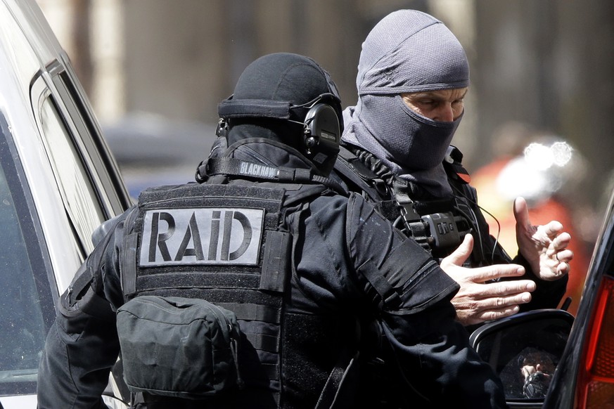 Hooded elite police officers discuss during searches in Marseille, southern France, Tuesday, April 18, 2017. Security concerns shook France&#039;s presidential campaign Tuesday as authorities announce ...