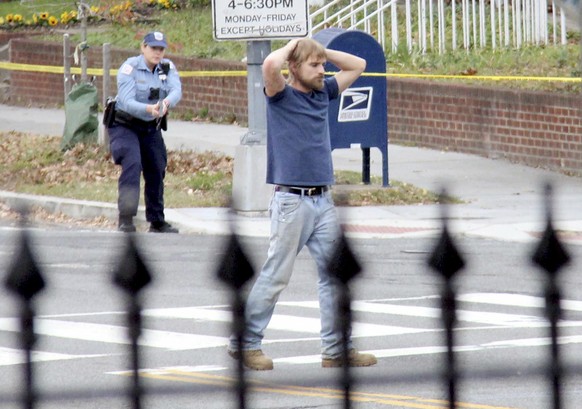 Edgar Maddison Welch, 28 of Salisbury, N.C., surrenders to police Sunday, Dec. 4, 2016, in Washington. Welch, who said he was investigating a conspiracy theory about Hillary Clinton running a child se ...