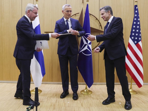 Finnish Foreign Minister Pekka Haavisto, left, hands over his nation&#039;s accession document to United States Secretary of State Antony Blinken, right, during a meeting of NATO foreign ministers at  ...