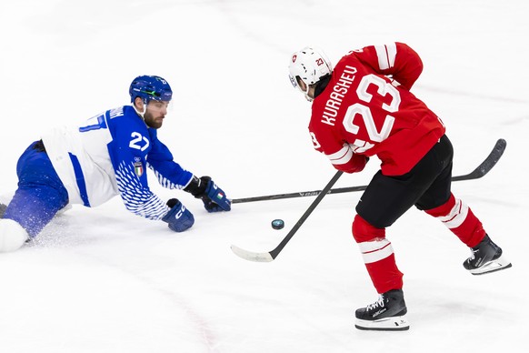 KEYPIX - Italy's Thomas Larkin #27 vies for the puck Switzerland's Philipp Kurashev #23, during the men's ice hockey playoff qualification between Switzerland and Italy at the 2026 Olym ...