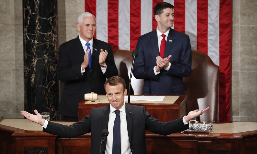 French President Emmanuel Macron gestures as he is introduced before speaking to a joint meeting of Congress on Capitol Hill in Washington, Wednesday, April 25, 2018. Standing behind him are Vice Pres ...