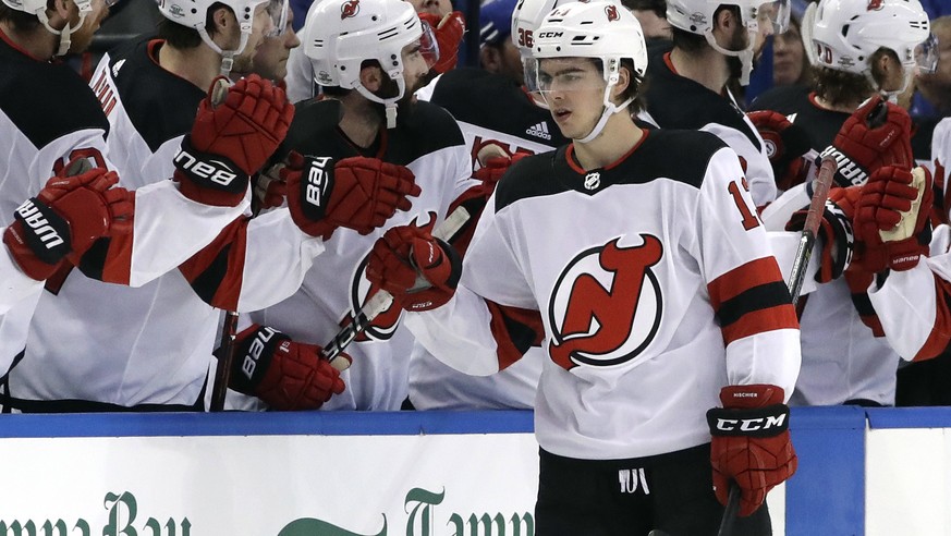 New Jersey Devils center Nico Hischier (13) celebrates his goal against the Tampa Bay Lightning with the bench during the second period of an NHL hockey game Saturday, Feb. 17, 2018, in Tampa, Fla. (A ...