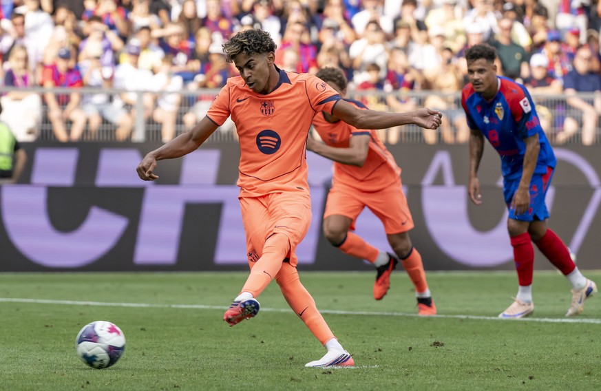 Barcelona's Lamine Yamal scores a goal with a penalty during a friendly soccer match between Switzerland's FC Basel 1893 and Spain's FC Barcelona at the St. Jakob-Park stadium in Basel, ...