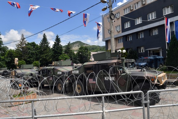 epa10668339 Vehicles of the NATO-led international peacekeeping Kosovo Force (KFOR) and Kosovo special police stand parked in front of the municipality building in Leposavic, Kosovo, 02 June 2023. At  ...
