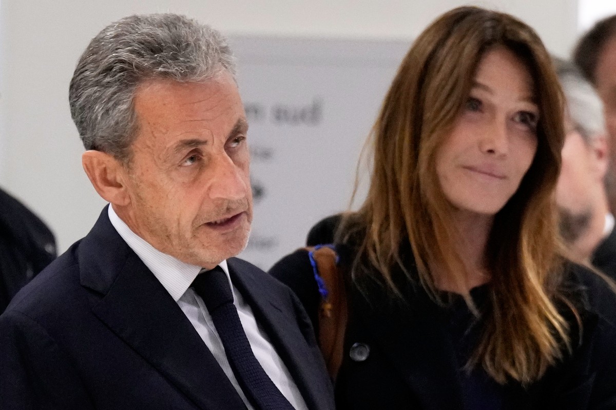 Former French President Nicolas Sarkozy, next to his wife Carla Bruni Sarkozy, speaks after a Paris court sentenced him to 5 years in prison and said he'll be incarcerated even if he appeals, aft ...