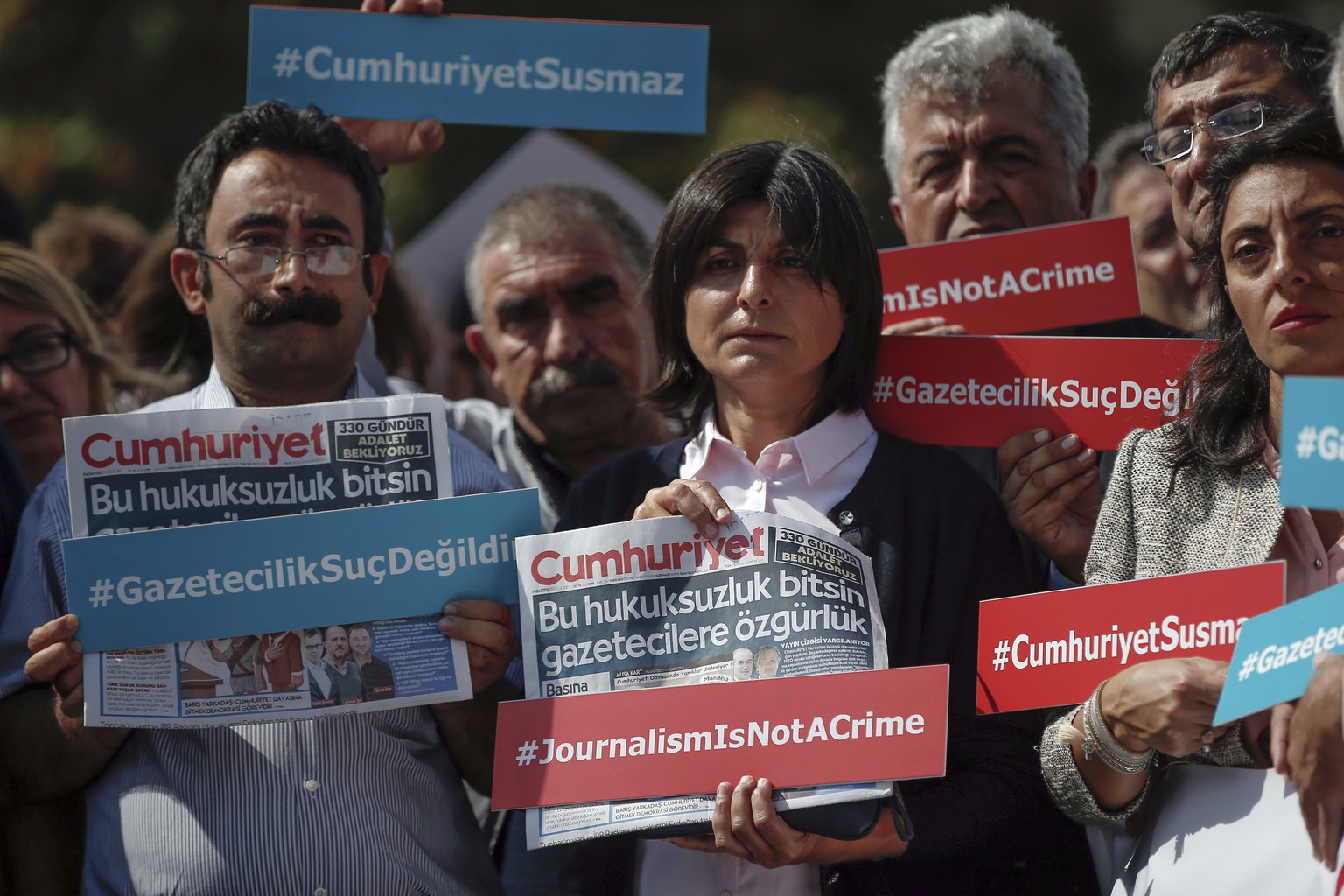 Journalists hold copies of Cumhuriyet hours before Kadri Gursel, a columnist for Cumhuriyet, Turkey&#039;s main opposition newspaper, being released from Silivri prison outside Istanbul, early Monday, ...