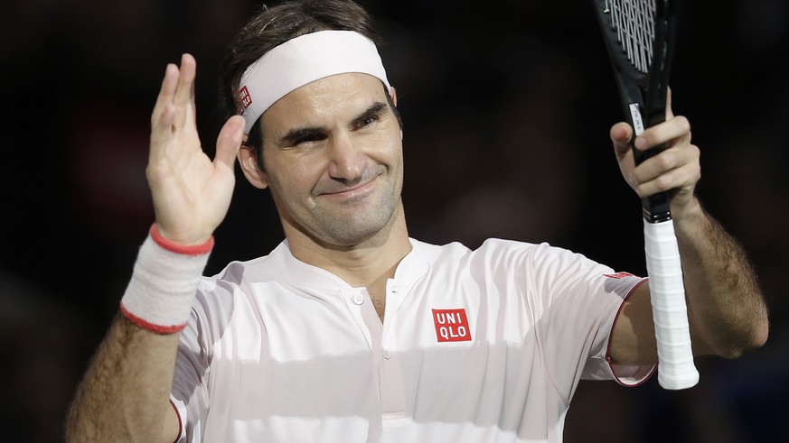 Roger Federer of Switzerland returns the ball to Kei Nishikori of Japan during their quarterfinal match of the Paris Masters tennis tournament at the Bercy Arena in Paris, France, Friday, Nov. 2, 2018 ...