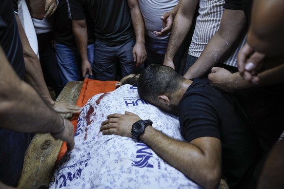 Palestinians mourn around the body of Mohammed Nada, 23, at the hospital&#039;s morgue ahead of his funeral in the West Bank city of Nablus, Wednesday, July 26, 2023. Israeli troops entered the Al-Ein ...